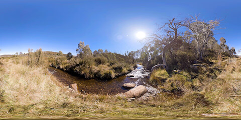Mountain Stream In Heathland Flowing Into Distance