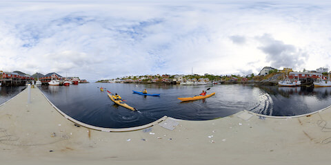 Kayakers Paddling Along End Of Jetty