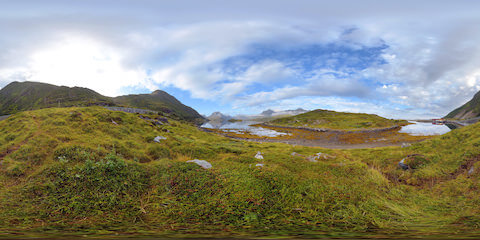 Mountain Reflection In Mirroring Lake With Sheep In Distance
