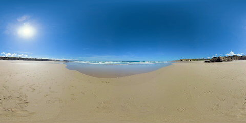 Waves Rolling Onto Wide Beach