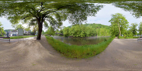 Fly Fisherman In Misty River Along Footpath In Historic German Village