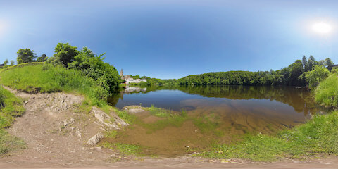 Idyllic Lake Flanked By Village And Forest