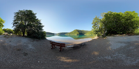 Wooden Bench Overlooking Glassy Lake