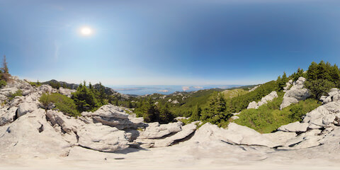 Epic Ocean View From Rock Overhang Onto Pine Forest And Islands