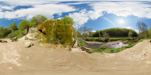 Cascading Water Glistening On Mossy Waterfall Near Creek