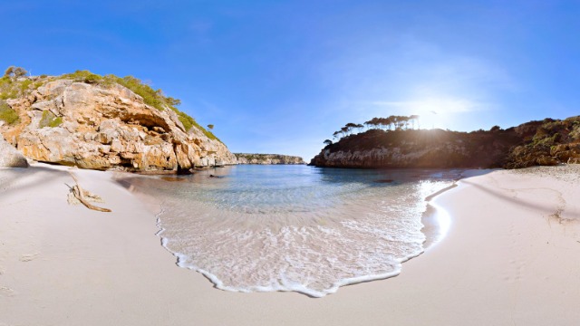 A hidden bay with gentle waves on white sand