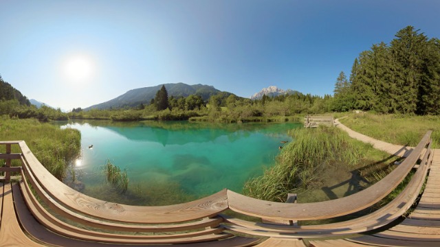 A vivid turquoise mountain lake ringed by forest